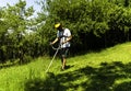 Man mowing green wild field Royalty Free Stock Photo