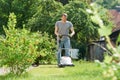 Man mowing lawn in backyard