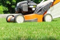 Man mowing the lawn with lawn mower in summer. Spring season sunny lawn mowing in the garden. Royalty Free Stock Photo