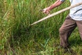 A man mows the grass with a scythe Royalty Free Stock Photo