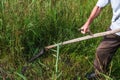 A man mows the grass with a scythe Royalty Free Stock Photo