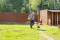 Man mows the grass with string trimmer Royalty Free Stock Photo