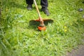 Man mows grass trimer. Close up Royalty Free Stock Photo