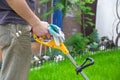 A man mows the grass with a trimmer Royalty Free Stock Photo