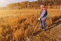 Man mows the grass with a trimmer, tall grass in a meadow, handmade in the garden Royalty Free Stock Photo