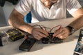 man with multimeter checking computer part Royalty Free Stock Photo