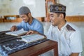 Man muslim learing to reading quran together during ramadan