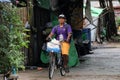 The man of Myanmarese ride a bicycle on the alley of street in Yangon.