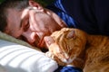 Man napping with cat