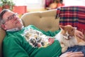 Man napping on couch with the cat during the holidays Royalty Free Stock Photo