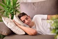 Man napping on a couch at home front view Royalty Free Stock Photo
