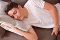 Man napping on a couch with cushions at home top Royalty Free Stock Photo