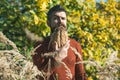 Man with natural spikelet beard sunny fall.