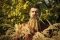 Man with natural spikelet beard sunny fall.