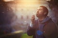 Man in nature. Harmony and romance. Dandelion blowing Royalty Free Stock Photo