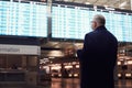 Man near airline schedule Royalty Free Stock Photo