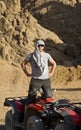 Man near ATV in desert Royalty Free Stock Photo