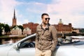 Man near cabriolet car over city of stockholm Royalty Free Stock Photo