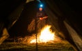 Man near camp fire at night Royalty Free Stock Photo