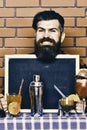 Barman, bartender or hipster holds bar advertising. Bar menu concept.