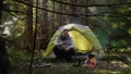 A man near a fire in the forest