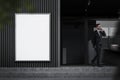 Man near office building with poster