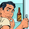 a man near the refrigerator with beer. Alcohol addiction