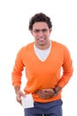 Man in need with stomach problems holding toilet paper in orange Royalty Free Stock Photo