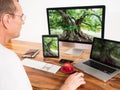 Man with networked computers and mobile devices