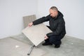 Man with new floor tiles Royalty Free Stock Photo