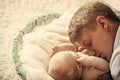 Man and newborn child sleep in crib on floor Royalty Free Stock Photo