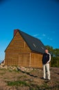 Man next to house in field Royalty Free Stock Photo
