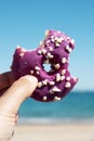 Man with a nibbled donut in his hand