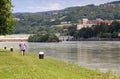 Man with Nordic walking poles walking along the Danube river. Persenbeug, Lower Austria. Royalty Free Stock Photo