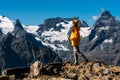 A man with Nordic walking sticks in the mountains. A man traveling in the Caucasus. Mountain sports. Mountain tourism.