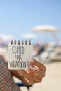 Man with a note with the text closed for vacation