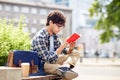 Man with notebook or diary writing on city street Royalty Free Stock Photo