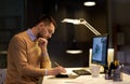 Man with notepad working at night office Royalty Free Stock Photo