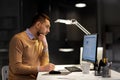 Man with notepad working at night office Royalty Free Stock Photo