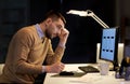 Man with notepad working at night office Royalty Free Stock Photo