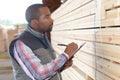 Man noting references from stack wood Royalty Free Stock Photo