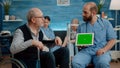 Man nurse and old patient looking at green screen on tablet Royalty Free Stock Photo