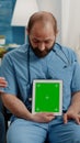 Man nurse vertically holding green screen on tablet Royalty Free Stock Photo