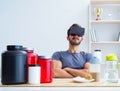 Man with nutrition jars and virtual reality glasses Royalty Free Stock Photo