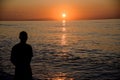 Man observes beautiful sea sunset Royalty Free Stock Photo