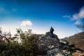 A man observes the horizon from the top of a hill