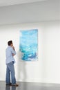 Man Observing Painting In Art Gallery Royalty Free Stock Photo