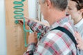 Man in occupational therapy with therapist training his dexterity