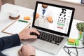 Man offering eyeglasses on a laptop screen, office desk background