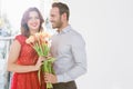 Man offering flower bouquet to woman